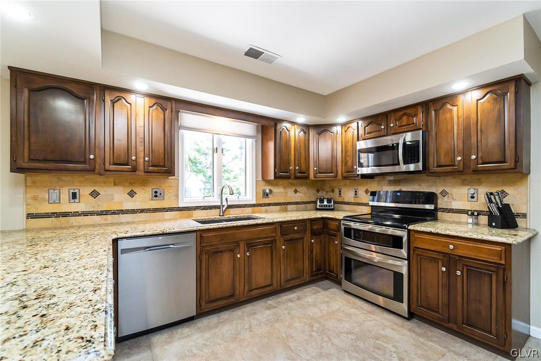 640 Macada Road Bethlehem, PA 18017 - Photo 15 of 48 a kitchen with sink a microwave and cabinets