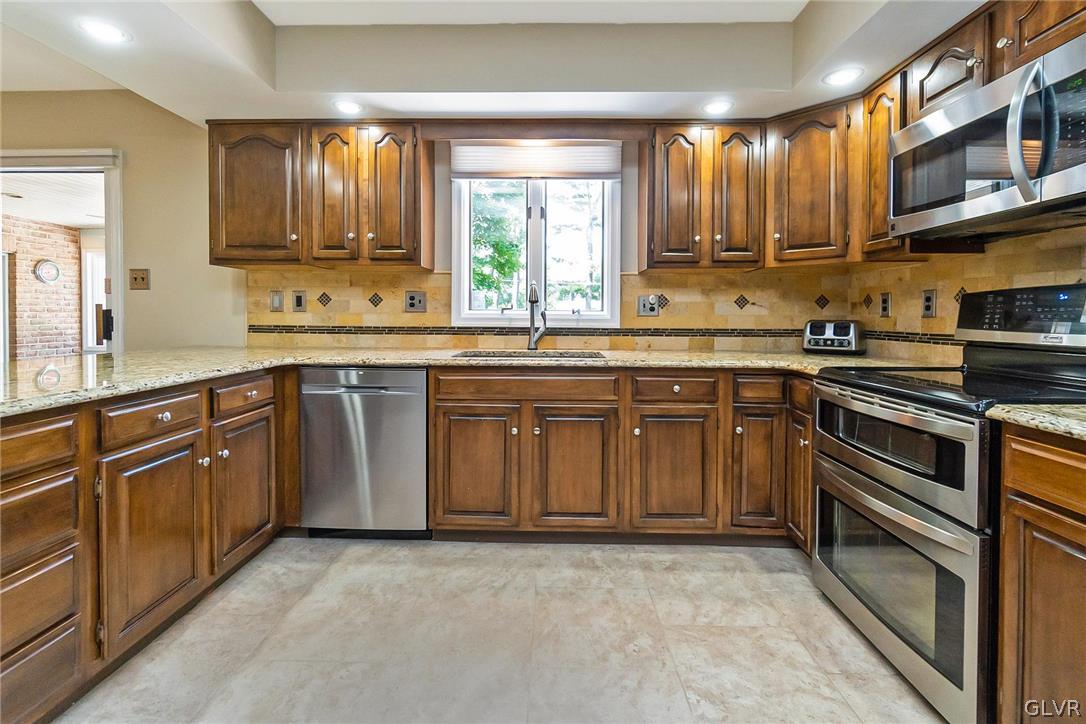 640 Macada Road Bethlehem, PA 18017 - Photo 16 of 48 a kitchen with a sink stove and cabinets