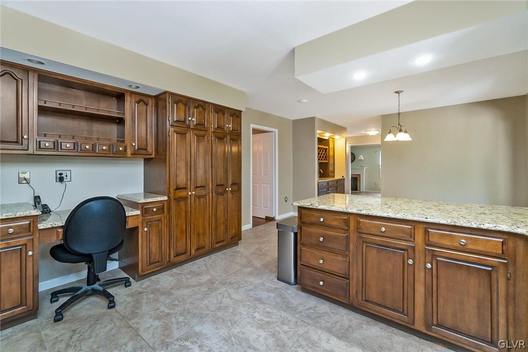 640 Macada Road Bethlehem, PA 18017 - Photo 17 of 48 a view of a kitchen with kitchen island granite countertop wooden cabinets and a refrigerator