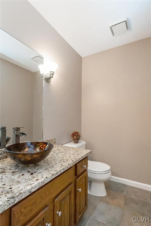 640 Macada Road Bethlehem, PA 18017 - Photo 21 of 48 a bathroom with a granite countertop sink a toilet and a mirror