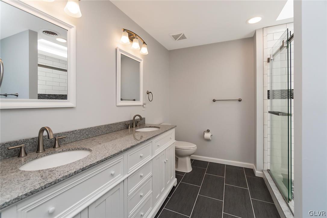 640 Macada Road Bethlehem, PA 18017 - Photo 31 of 48 a bathroom with a granite countertop sink toilet and shower
