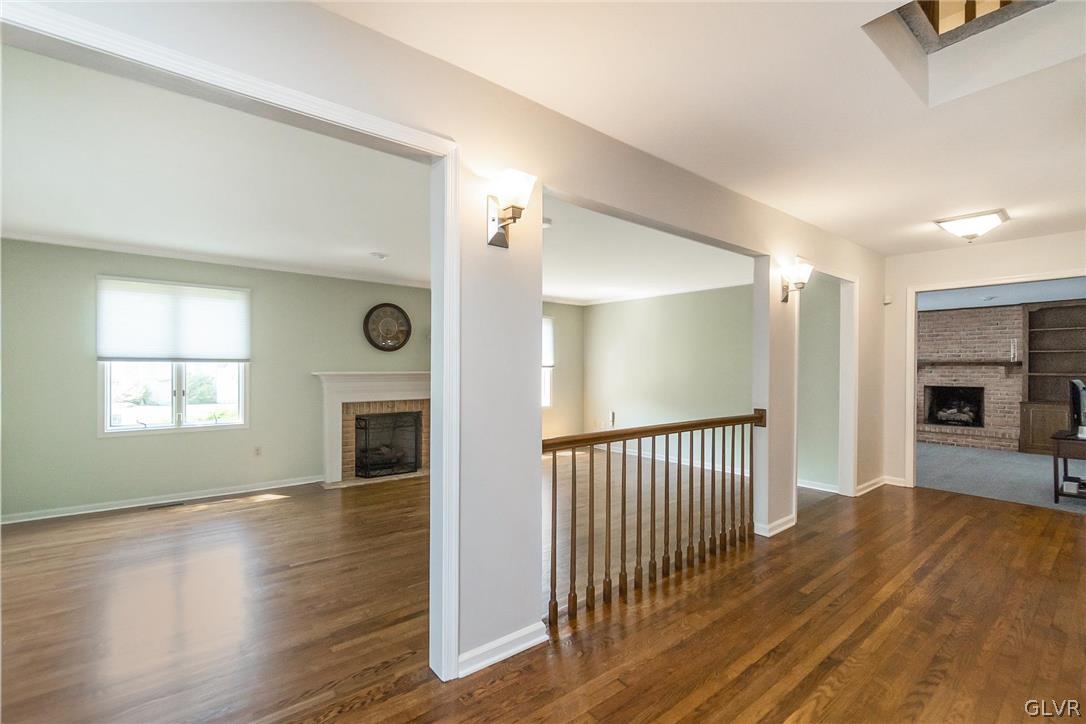 640 Macada Road Bethlehem, PA 18017 - Photo 6 of 48 an empty room with wooden floor fireplace and windows
