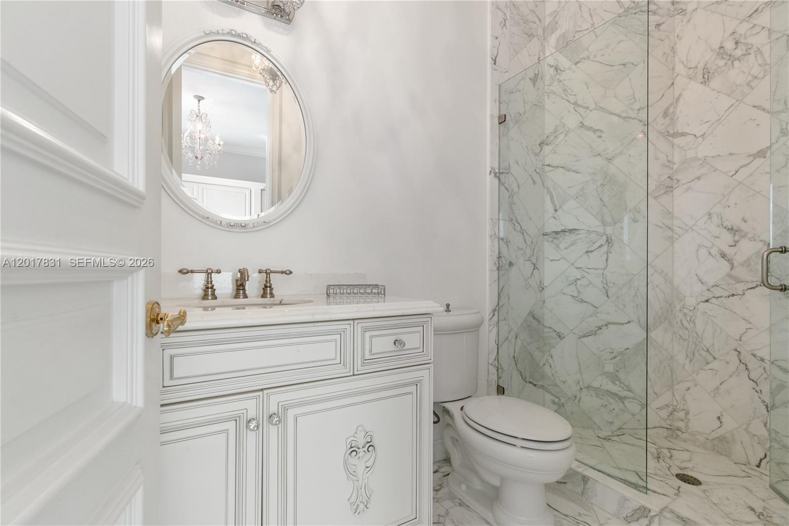 2951 Lake Ridge Lane Weston, FL 33332 - Photo 46 of 64 a bathroom with a granite countertop toilet a sink and a mirror