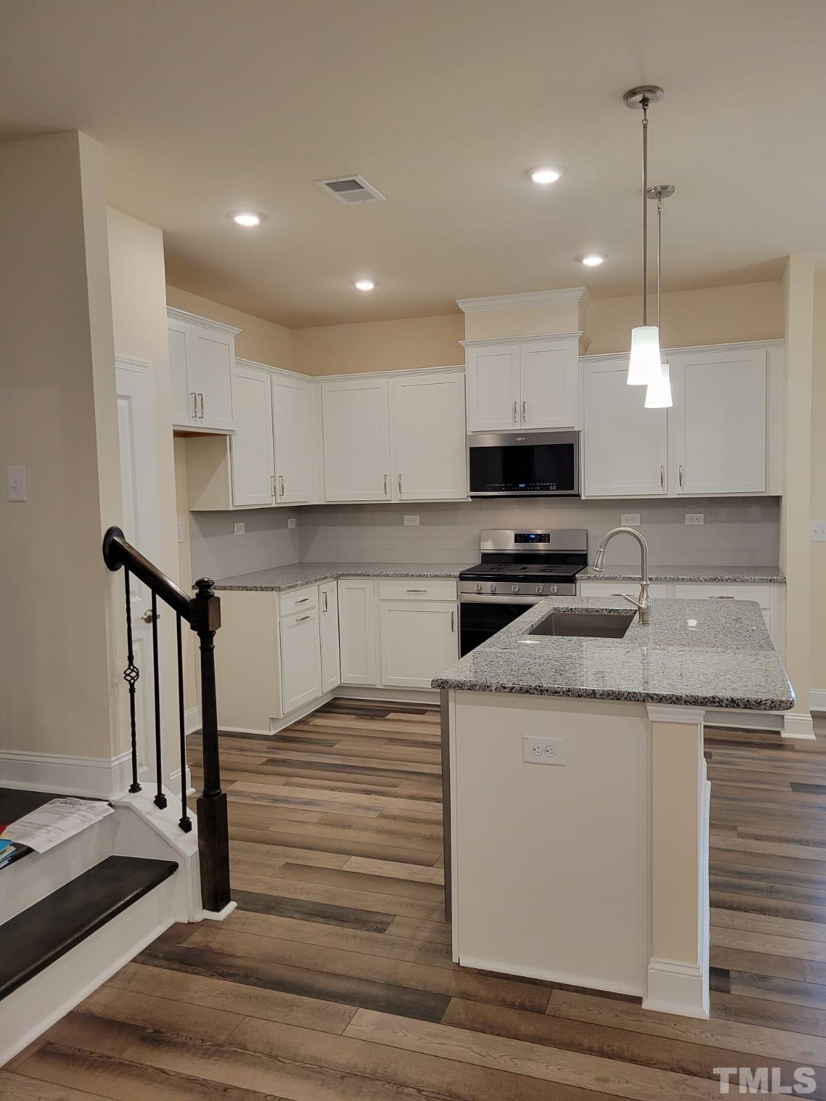 1178 Citadel Avenue Durham, NC 27713 - Photo 5 of 15 a kitchen with granite countertop a stove and a sink