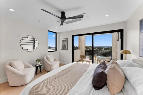 a bedroom with a large bed and a large window