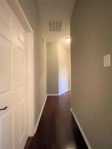 a view of hallway with wooden floor