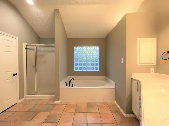 a bathroom with a bathtub and a shower