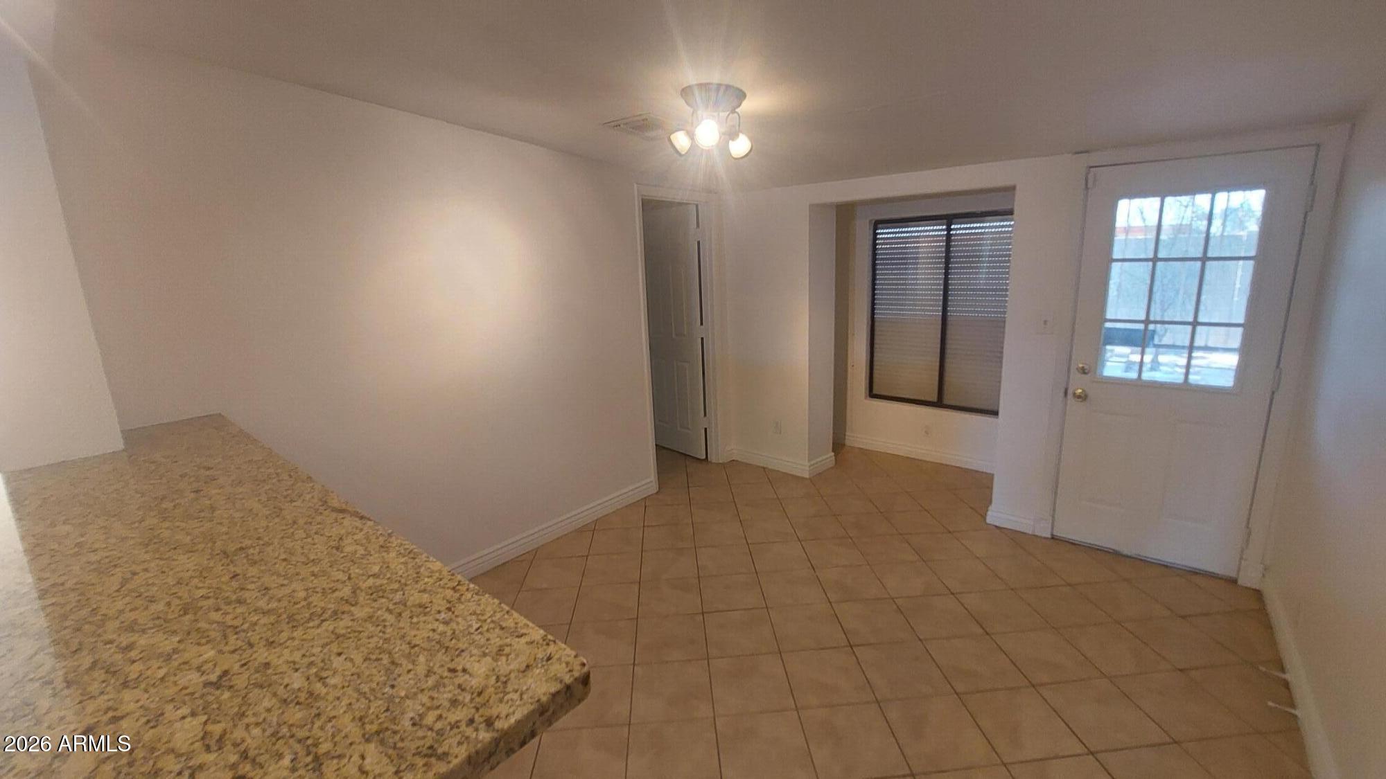 2448 West Freeway Lane Phoenix, AZ 85021 - Photo 12 of 27 an empty room with windows