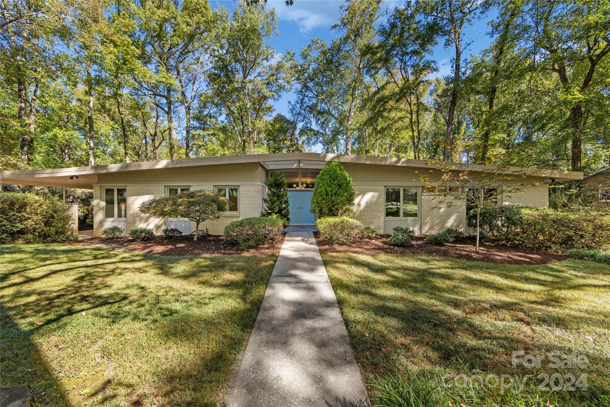 a view of a patio with table and chairs under an umbrella