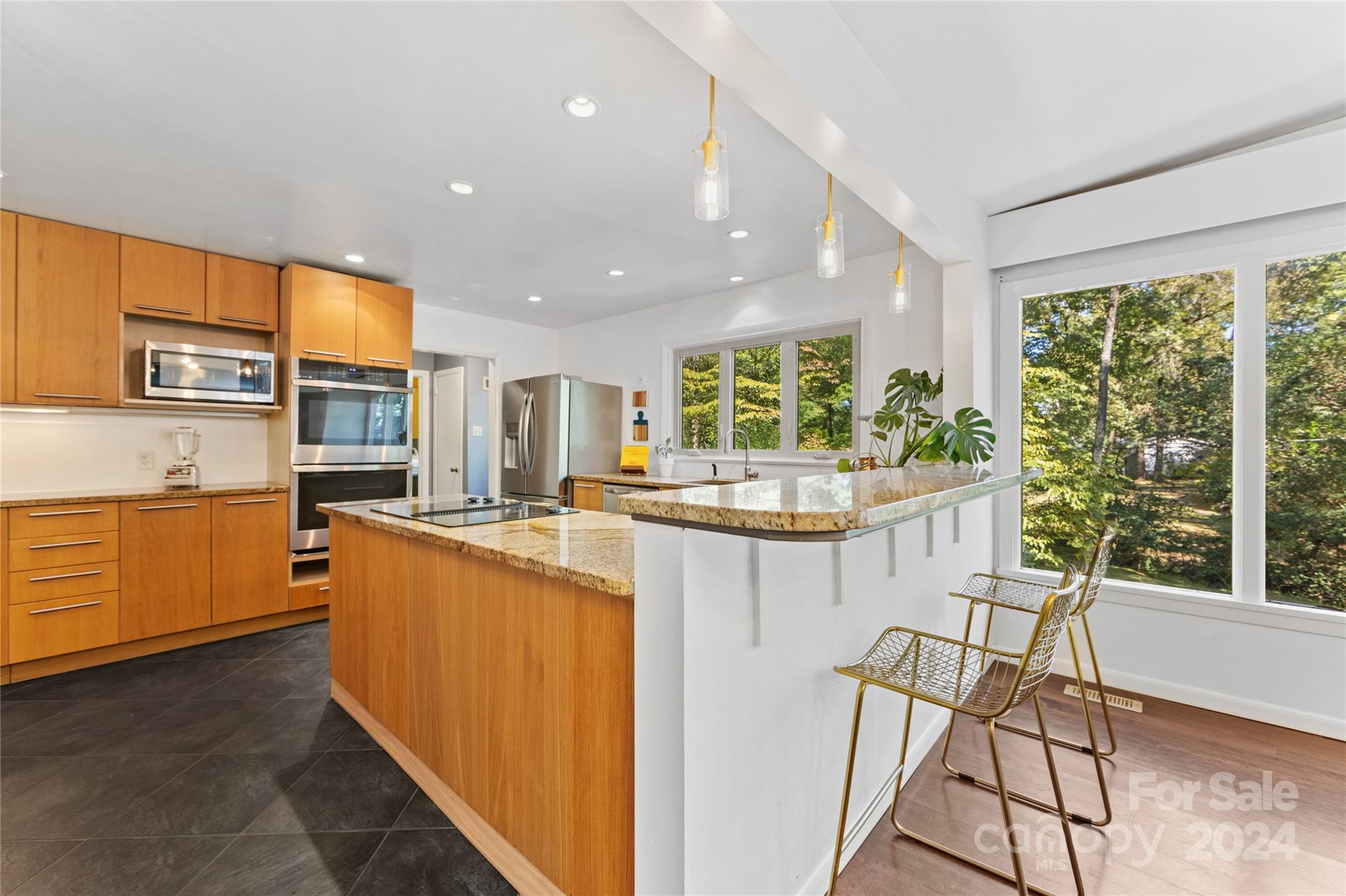 5601 Riviere Drive Charlotte, NC 28211 - Photo 11 of 38 a kitchen with stainless steel appliances granite countertop counter space and a large window