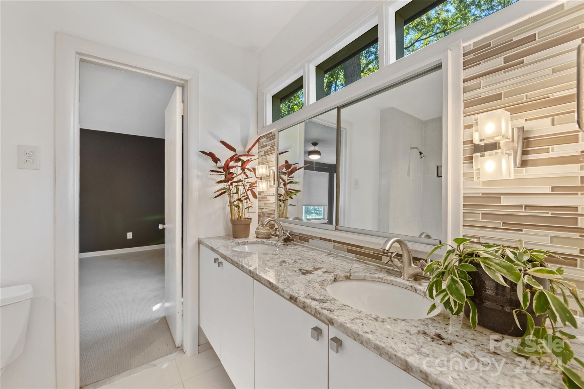5601 Riviere Drive Charlotte, NC 28211 - Photo 23 of 38 a bathroom with a granite countertop sink and a mirror
