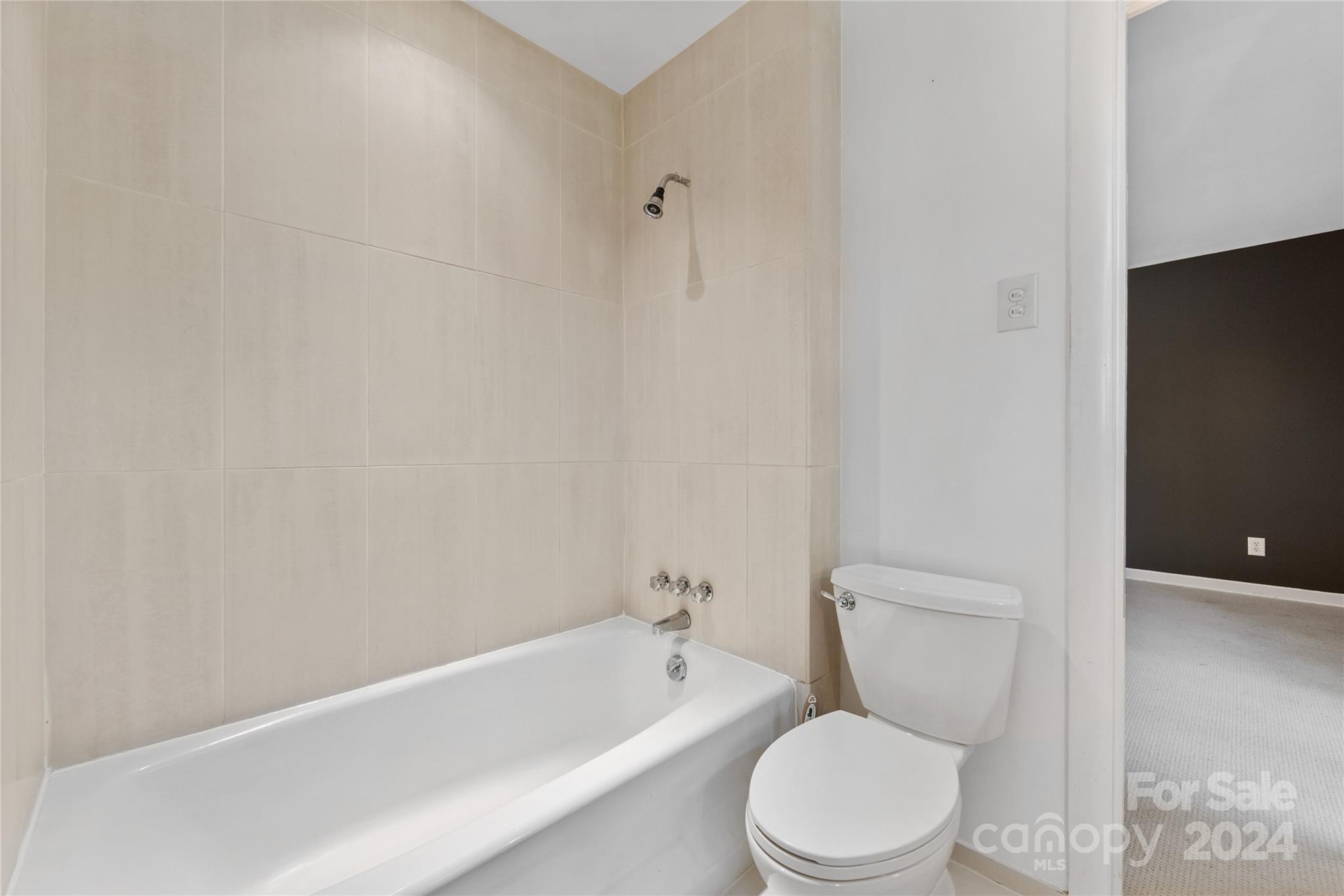 5601 Riviere Drive Charlotte, NC 28211 - Photo 24 of 38 a white toilet and tub sitting next to a white cabinet