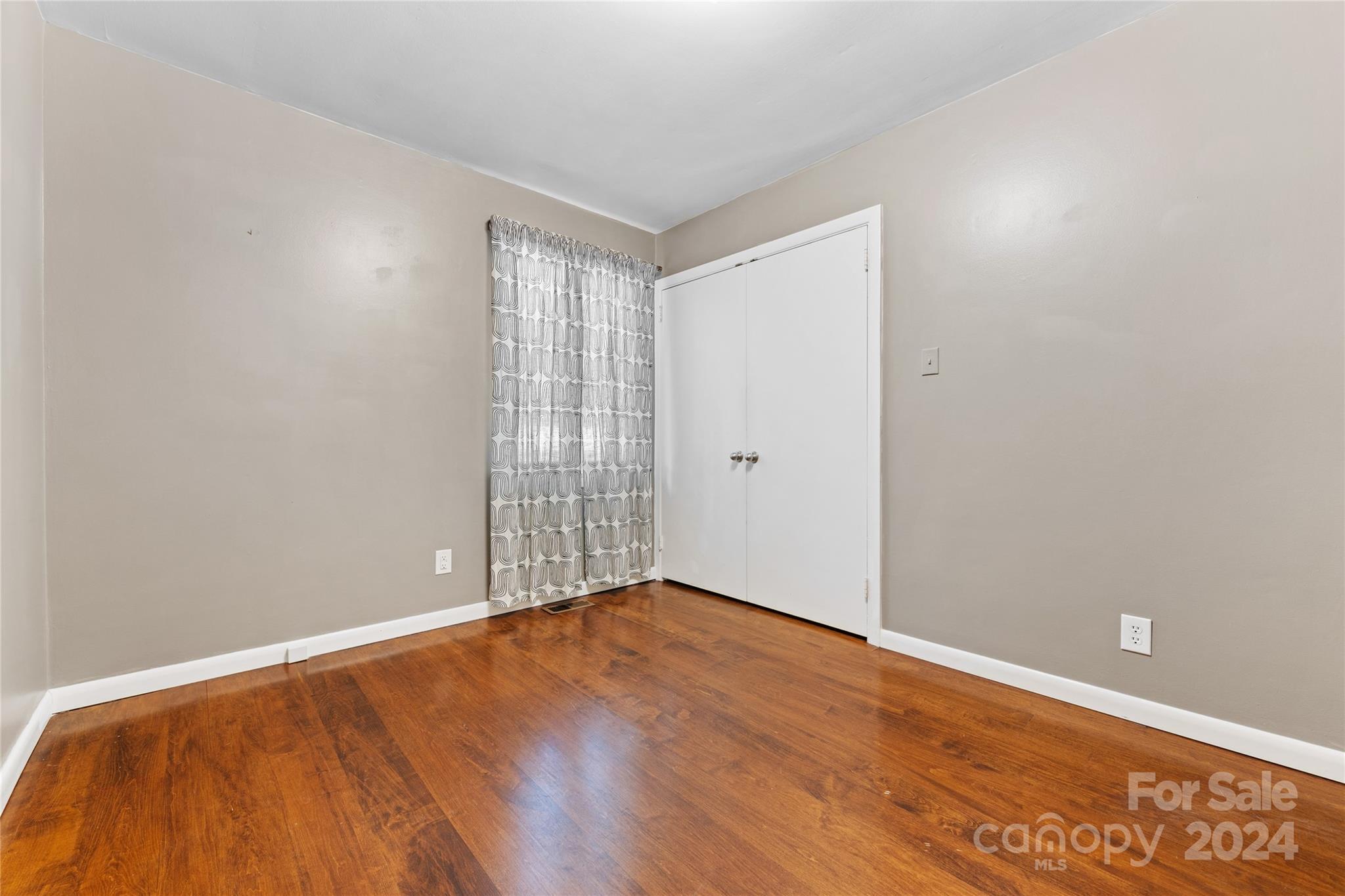5601 Riviere Drive Charlotte, NC 28211 - Photo 26 of 38 a view of an empty room with wooden floor and a window
