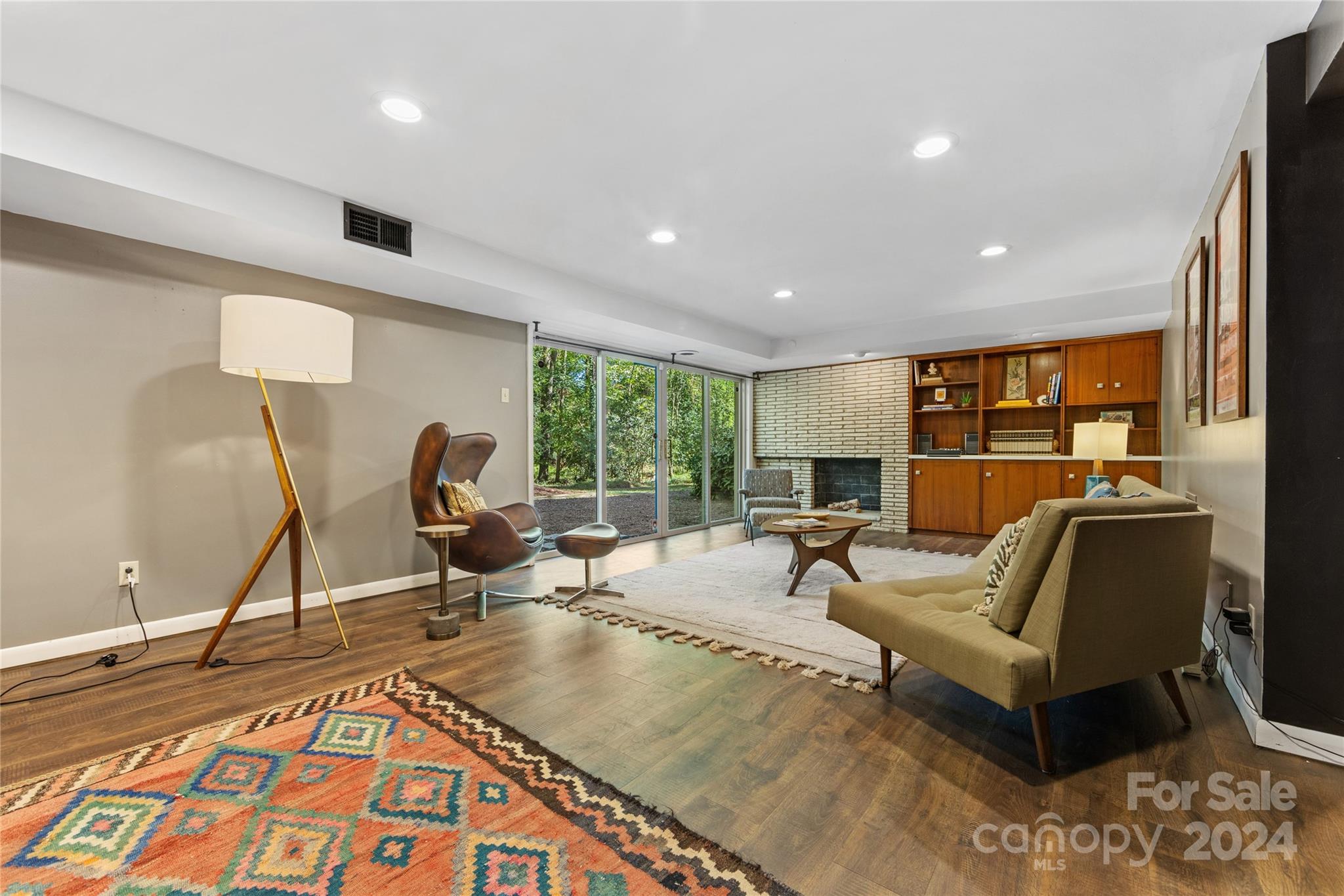 5601 Riviere Drive Charlotte, NC 28211 - Photo 30 of 38 a living room with furniture a flat screen tv and a large window