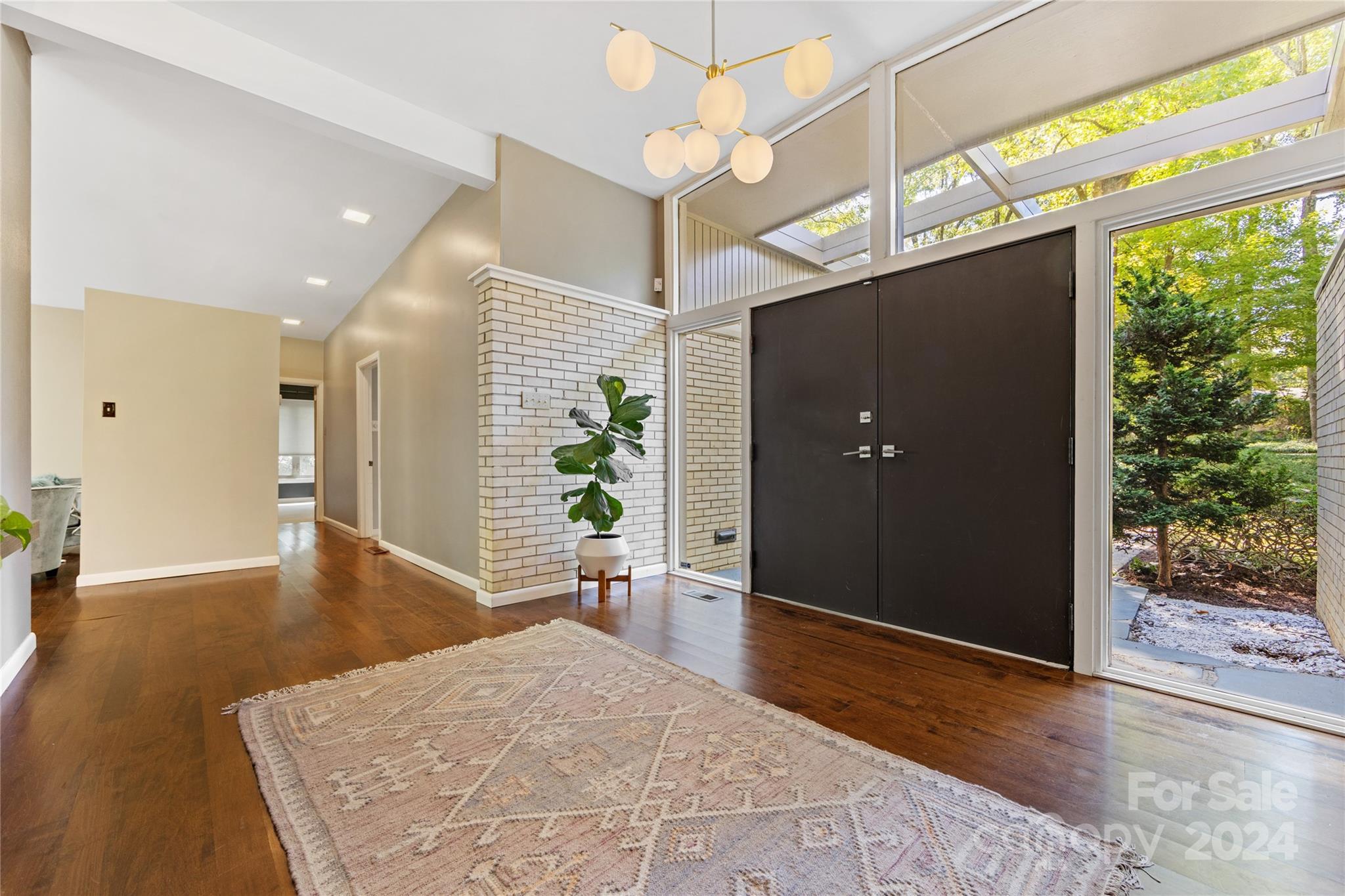 5601 Riviere Drive Charlotte, NC 28211 - Photo 5 of 38 a view of a hallway with dining room and wooden floor