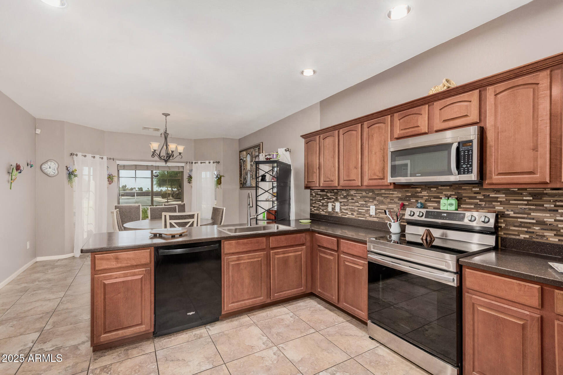 108 East Ridgeview Trail Casa Grande, AZ 85122 - Photo 9 of 34 a kitchen with stainless steel appliances granite countertop a sink stove and microwave