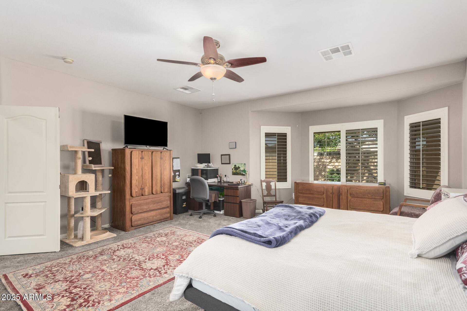 108 East Ridgeview Trail Casa Grande, AZ 85122 - Photo 14 of 34 a bedroom with a bed flat screen tv and a large window