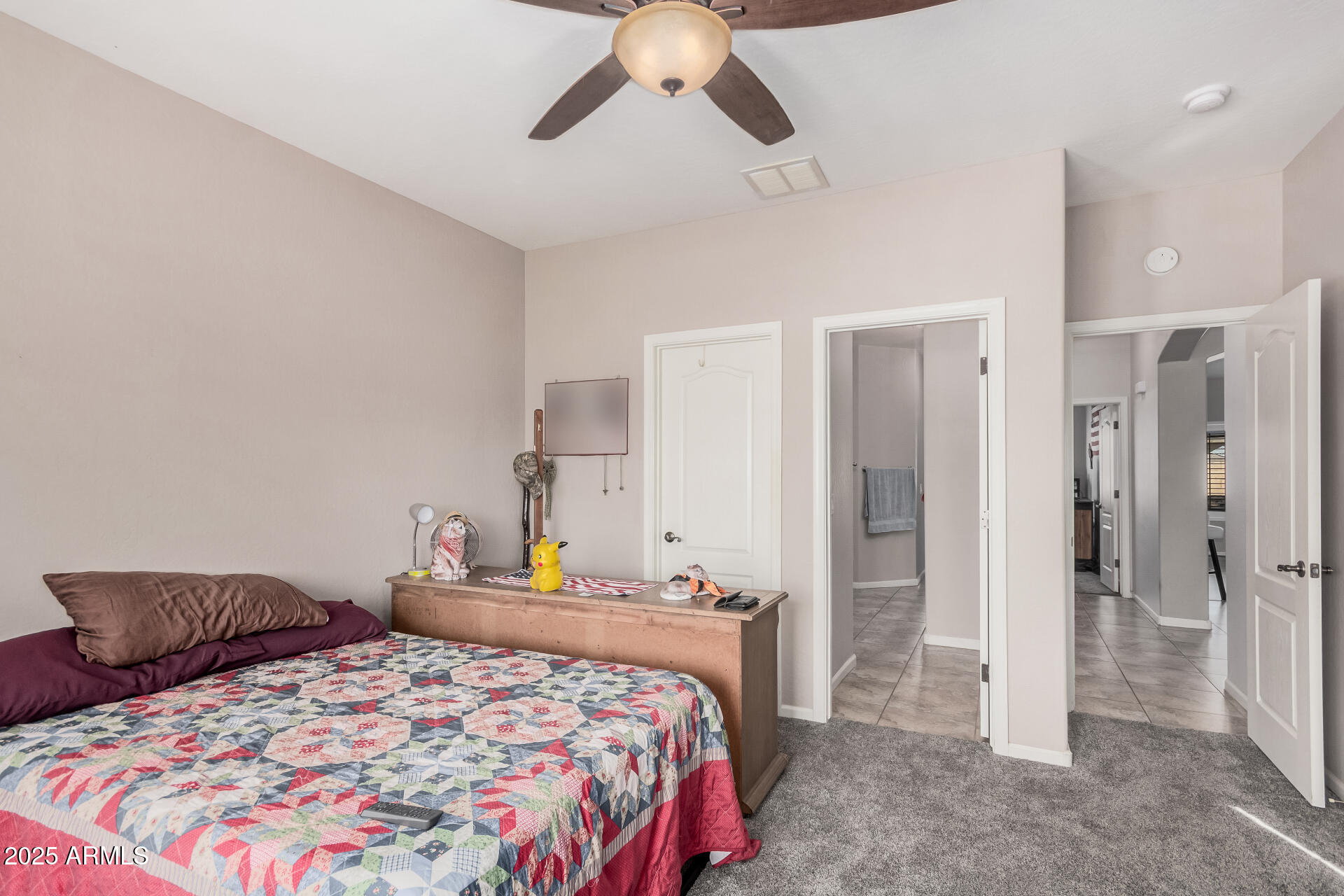 108 East Ridgeview Trail Casa Grande, AZ 85122 - Photo 20 of 34 a bedroom with a bed and a chandelier