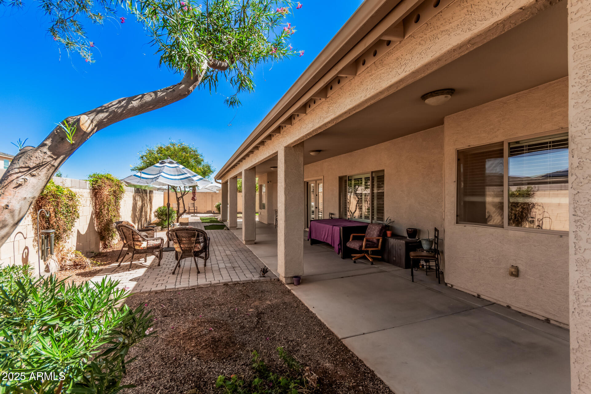 108 East Ridgeview Trail Casa Grande, AZ 85122 - Photo 28 of 34 a view of a patio with table and chairs potted plants and large tree