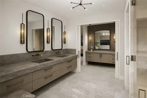 a bathroom with a double vanity sink and a mirror