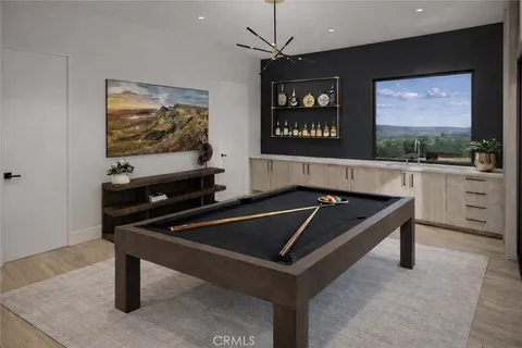 a room with furniture pool table and painting on the wall