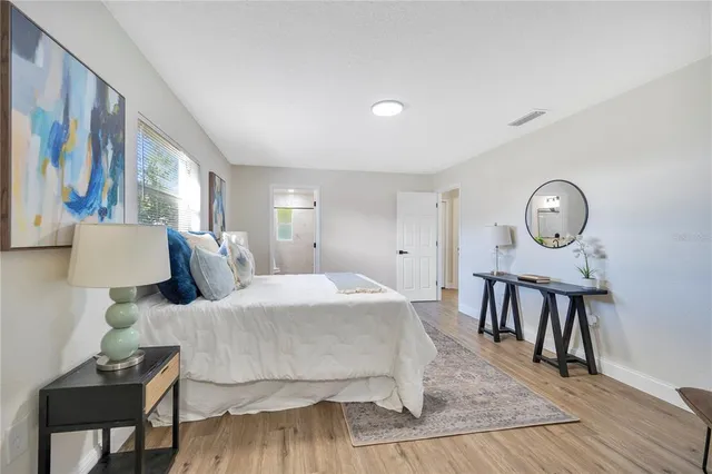 a bed room with a bed window and a chair