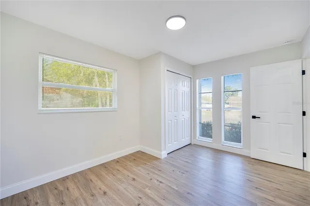 a bathroom with a granite countertop sink a toilet a mirror a bathtub and shower