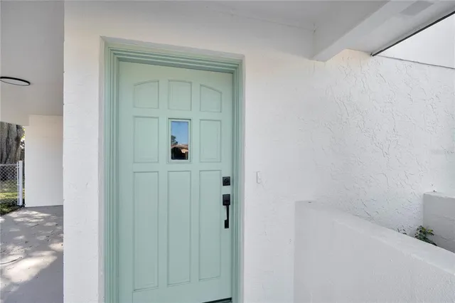 a living room with furniture and view of kitchen