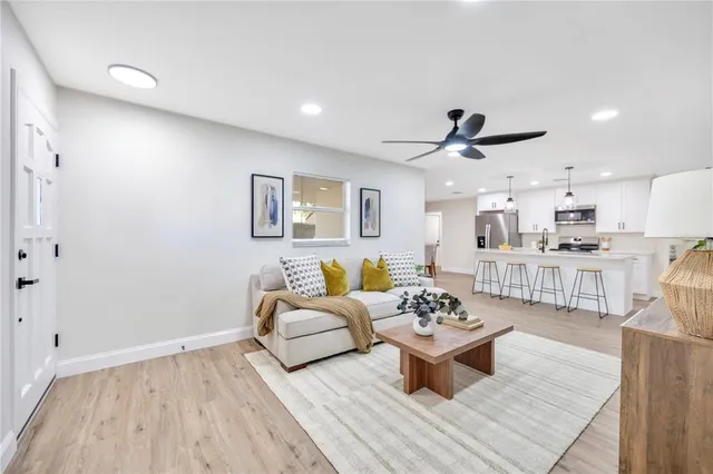 a living room with furniture and a wooden floor