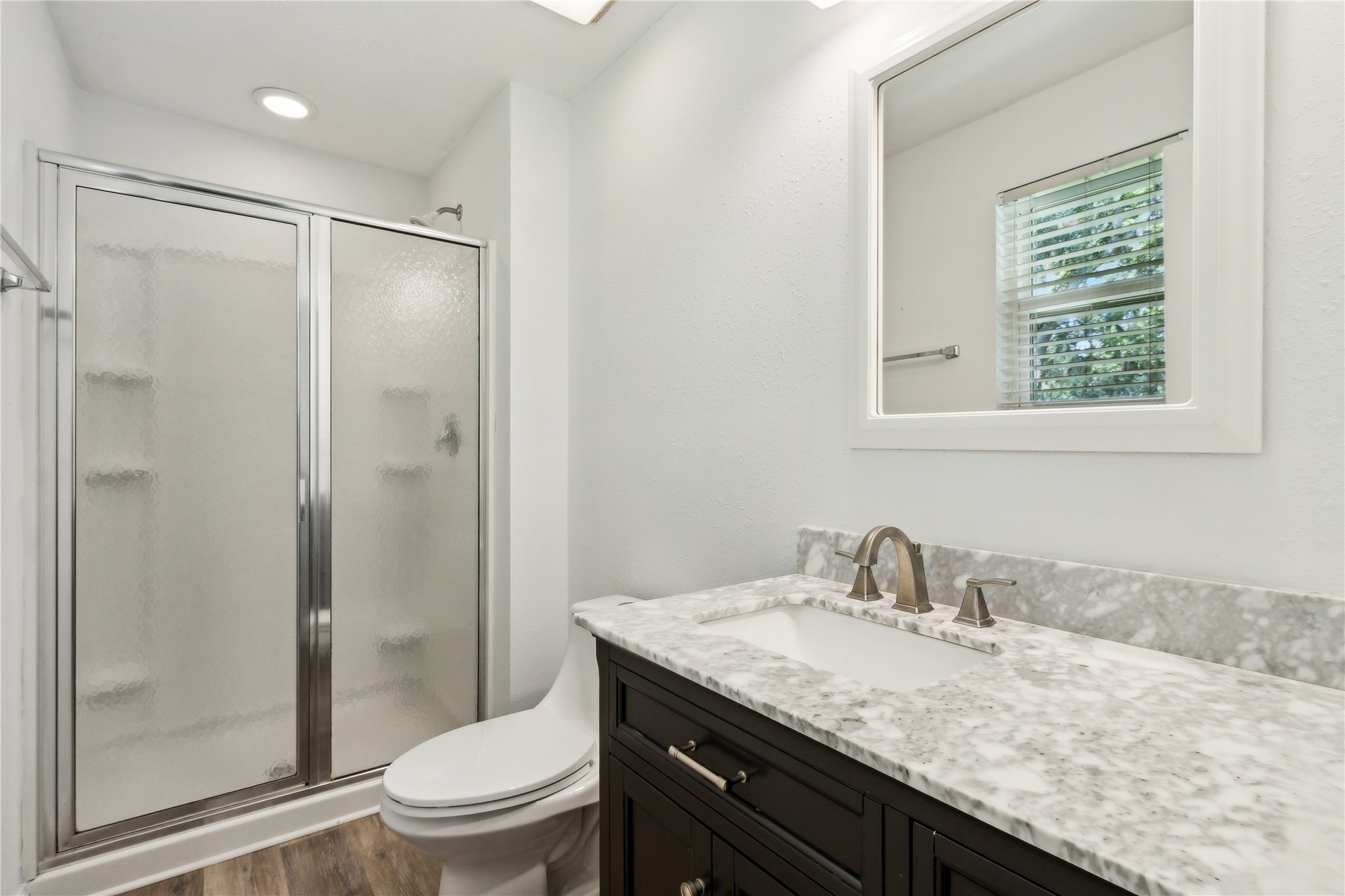 2441 Amelia Road Fernandina Beach, FL 32034 - Photo 29 of 36 a bathroom with a granite countertop sink toilet and shower