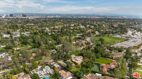 an aerial view of residential houses with city view