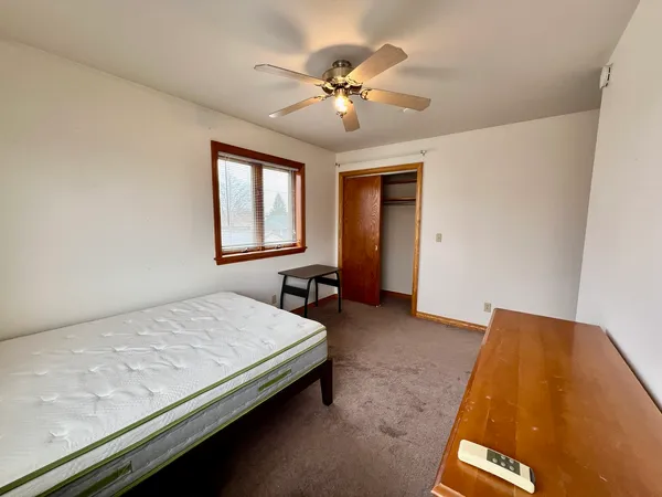 a bedroom with a bed and window
