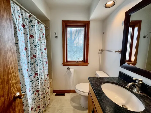 a bathroom with a sink toilet and mirror