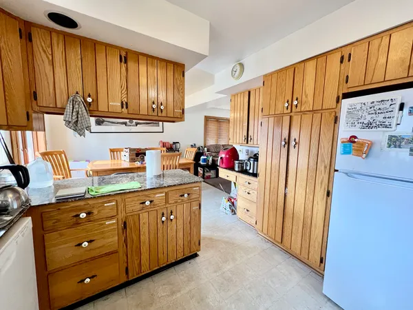 a kitchen with stainless steel appliances a refrigerator and cabinets