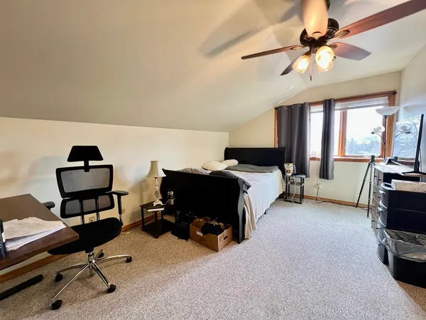 a bed room with a bed and a chair