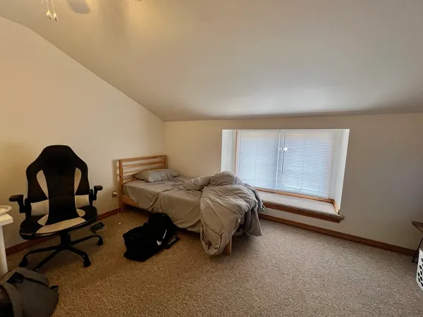 a bedroom with a bed and a window