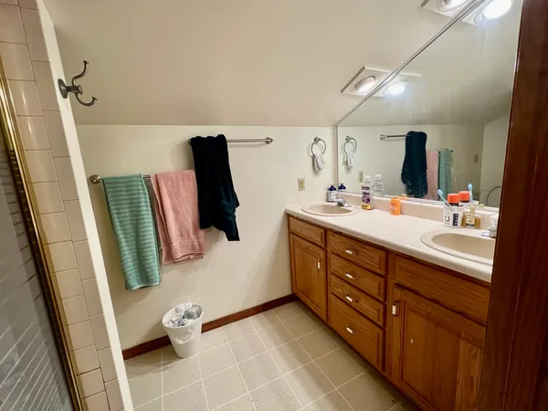 a bathroom with a double vanity sink and mirror