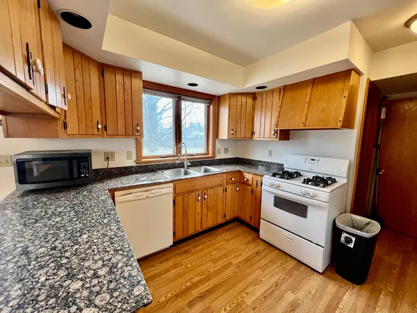 a kitchen with a stove a sink and a microwave