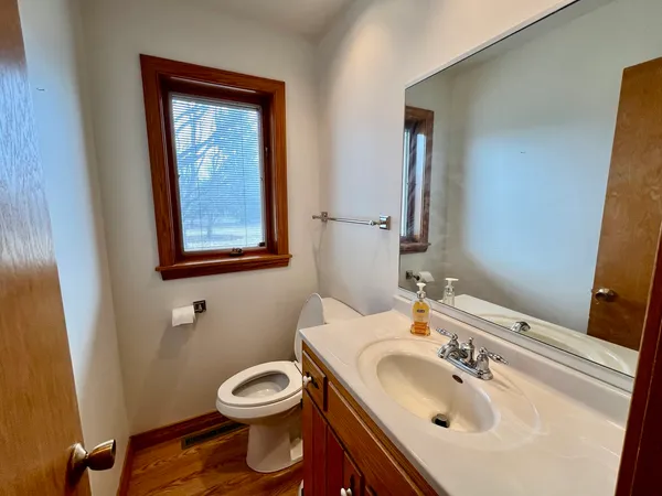 a bathroom with a toilet sink and mirror