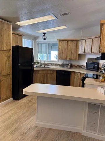 a kitchen with a refrigerator and a stove top oven