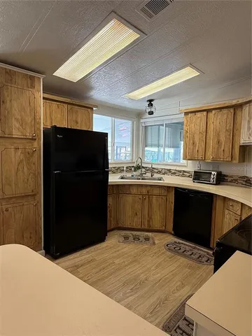 a kitchen with a refrigerator and a cabinets