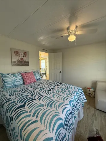 a bedroom with a large bed and a chandelier