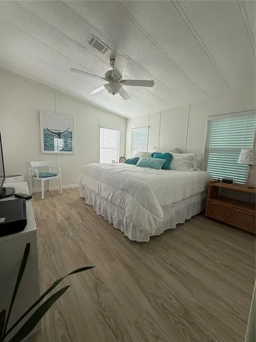 a bedroom with double bed and a night stand