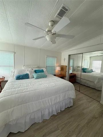 a bedroom with a large bed and a chandelier