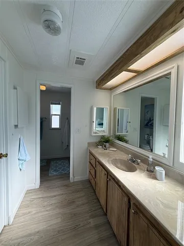 a bathroom with a granite countertop sink mirror and vanity