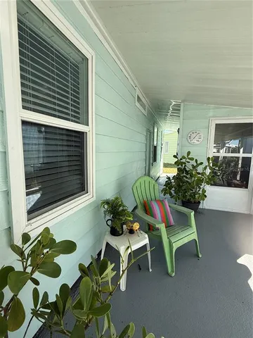 a view of a chairs and table in a back yard of the house