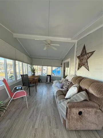 a living room with furniture and a large window