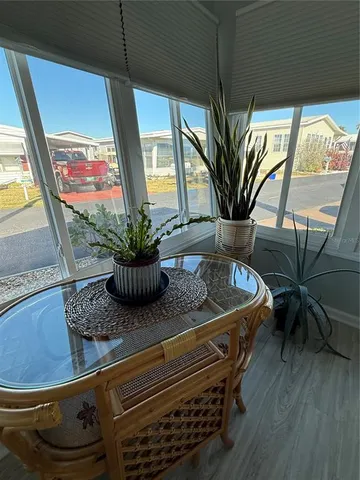 a view of a living room with furniture and a potted plant