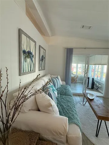 a living room with furniture and a painting on the wall