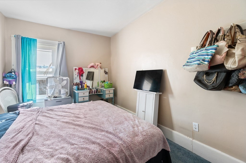 48 Danforth Street Taunton, MA 02780 - Photo 20 of 42 a bedroom with a bed and a flat screen tv